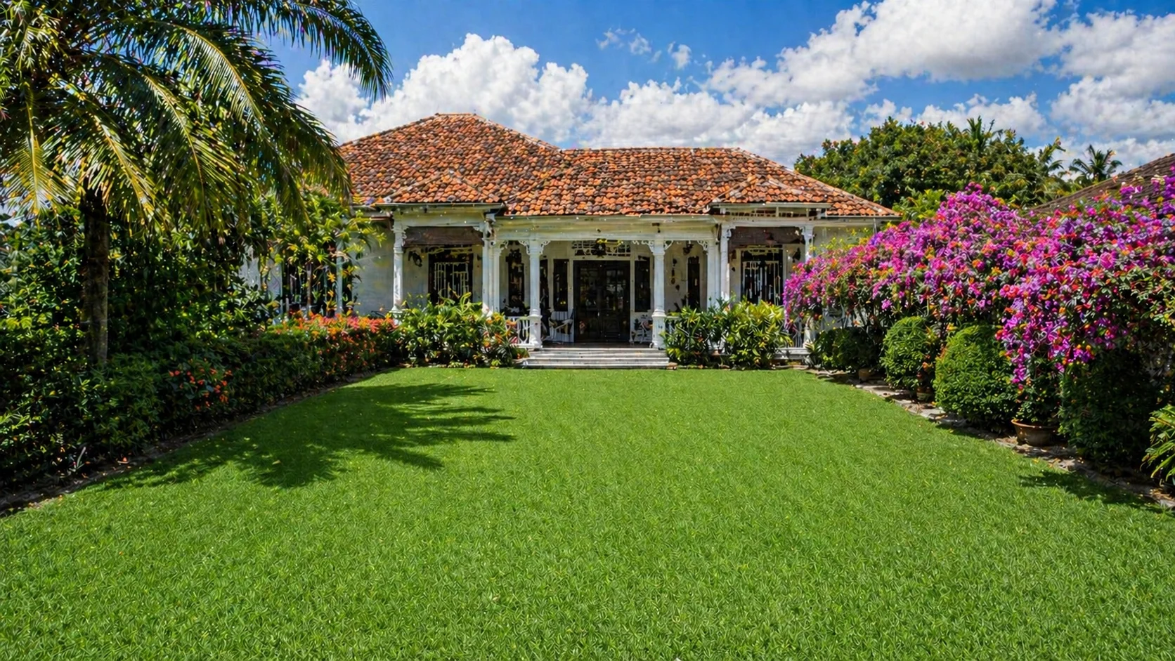 Malaysian bungalow garden with tropical lawn