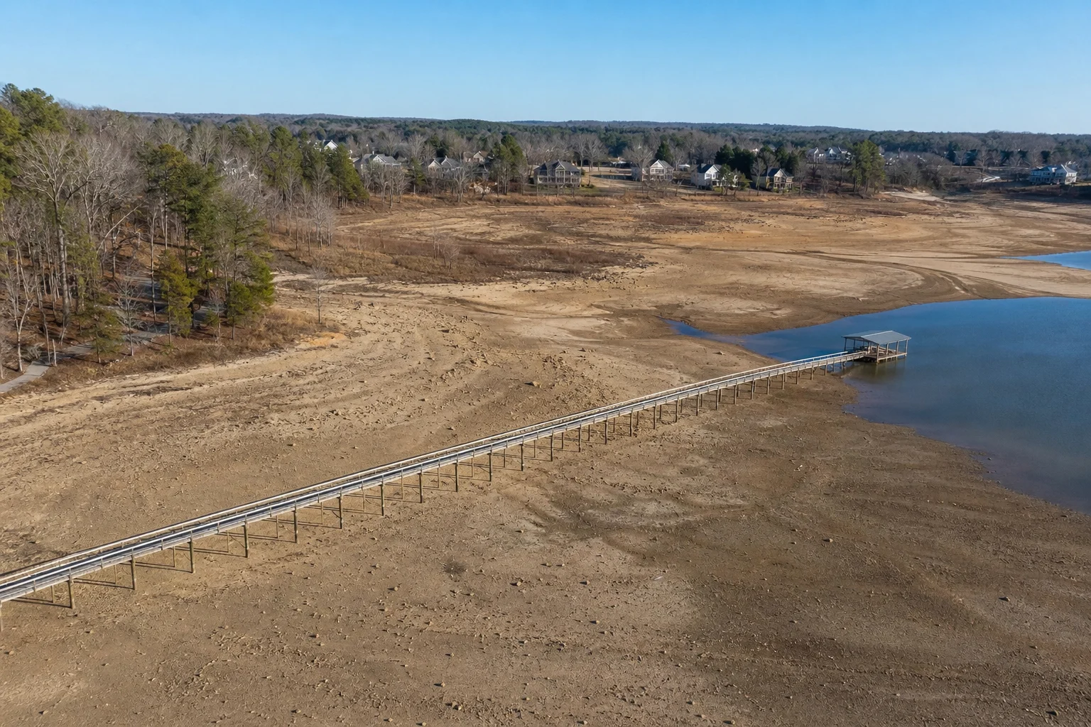 Falls Lake reservoir near Raleigh showing visibly low water levels and exposed shoreline